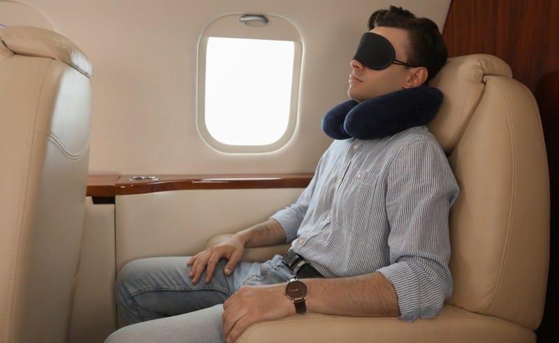 A man wearing a sleep mask in air travel
