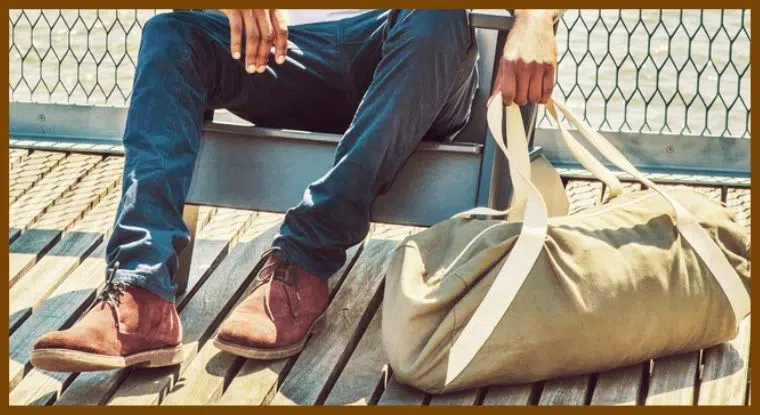 A traveler carrying a packable duffel bag